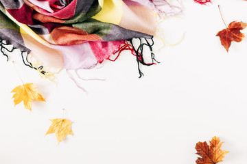 Autumn cozy composition. Dry leaves, flowers, checkered plaid on white background. Fall concept. Autumn background. Flat lay, top view, copy space