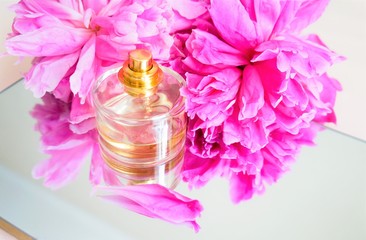 perfume bottle glass, pink peony petals. flower. fuchsia