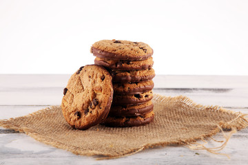 Chocolate cookies on wooden table. Chocolate chip cookies shot on wooden white table