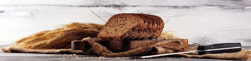 freshly baked bread on wooden board. cutted organic bread