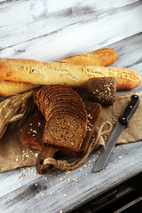freshly baked bread on wooden board. cutted organic bread