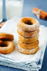 Baked pumpkin donuts with glasses of milk