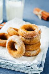 Baked pumpkin donuts with glasses of milk