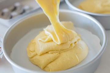 Pouring Cake Batter Out of Mixing Bowl