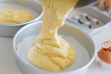 pouring vanilla batter into cake pan