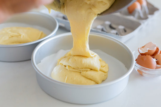 Pouring Cake Batter Out of Mixing Bowl