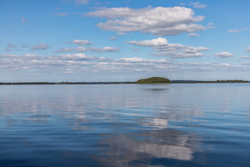 Island, Clouds and reflections in Lough Corrib lake