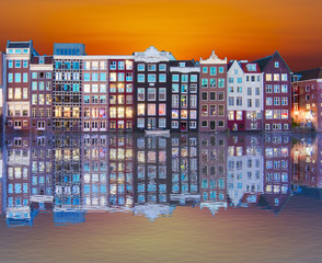 Amsterdam architecture along Damrak canal at sunrise, Netherlands