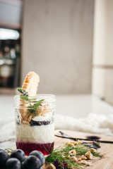 Vanilla Panna Cotta with a Concord Grape Gelee Topped with Whipped Chantilly Cream and Toasted Hazelnut and Served with a Slice of Hazelnut Biscotti