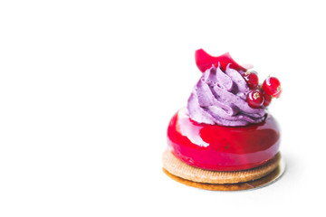 Cake covered with red mirror glaze and violet cream and currant isolated on white background. . Pastry sweet dessert concept. Bakery design element. Restourant interior