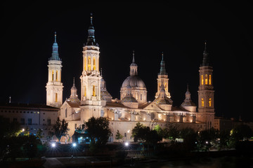 Fototapeta na wymiar Night View Of The Basilica Of The Virgen Del Pilar And Ebro River, Zaragoza, Aragon, Spain .