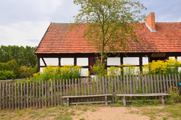 Old whitewashed house in The Folk Culture Museum in Osiek by the river Notec, the ethnographic park covers an area of 13 ha. Poland, Europe