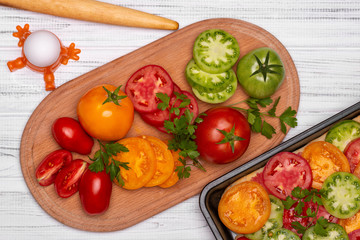 Cooking vegetarian pizza with different types of tomatoes