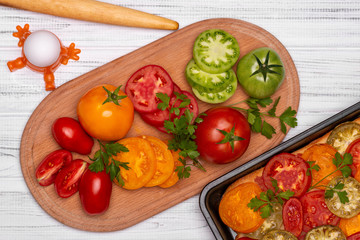 Cooking vegetarian pizza with different types of tomatoes