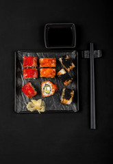 Set of sushi rolls on stone table. Top view with copy space