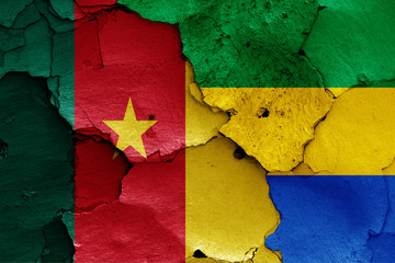 flags of Cameroon and Gabon painted on cracked wall