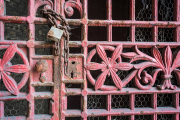 Weathered steel door with padlock.