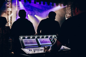 Sound technician control professional audio mixer in concert
