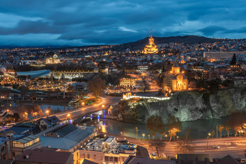Obraz premium Evening view of Tbilisi with Sameba (Trinity) Church and other landmarks. Travel.