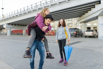 Teens boy and two girls talking and having fun outdoor