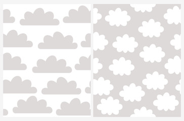 Fototapeta premium Simple Cloudy Vector Patterns. Cute Gray Clouds Isolated on a White Background. White Fluffy Clouds on a Light Gray Sky. Gender Neutral Colors.
