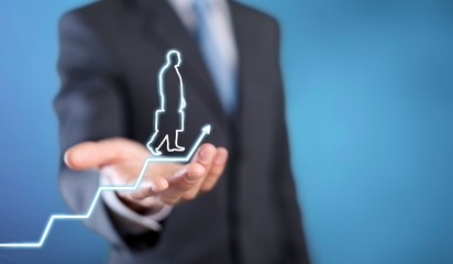 Businessman holding digital glowing graph with silhouette