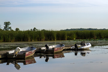 Three rental fishing boats on the Fox River at Chain O' Lakes State Park in Illinois