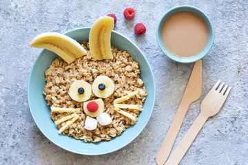 Funny breakfast for a child - oatmeal porridge bunny with berries. Back to school.