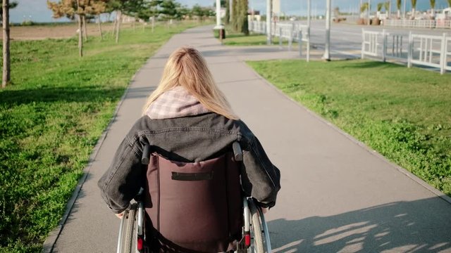 Woman in wheelchair on outdoor walk