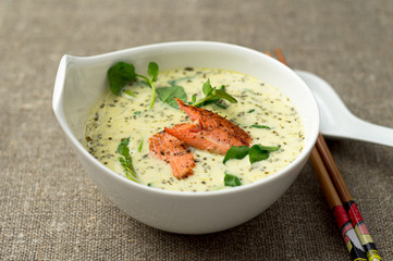 Tom kha asian coconut soup bowl. One of the most popular Thai food, tom kha is a spicy and sour soup with coconut milk. Vermicelli noodles and salmon are added in this version of the dish.