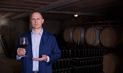 Winemaker offering red wine for tasting