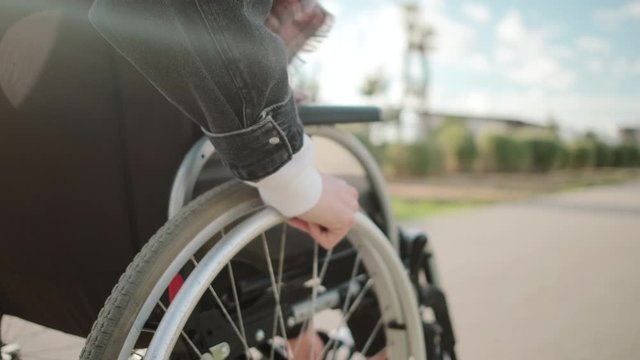 Outdoor walk of woman in wheelchair