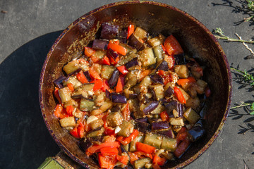 fried or fried eggplant, carrots, bell peppers, onions in a pan