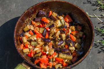 fried or fried eggplant, carrots, bell peppers, onions in a pan