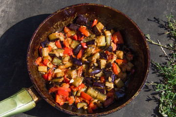 fried or fried eggplant, carrots, bell peppers, onions in a pan