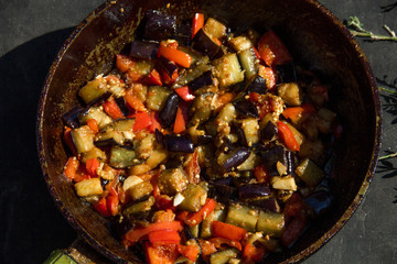 fried or fried eggplant, carrots, bell peppers, onions in a pan