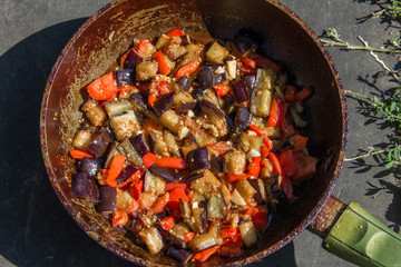 fried or fried eggplant, carrots, bell peppers, onions in a pan