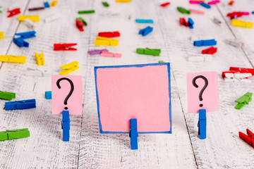 Scribbled and crumbling sheet with paper clips placed on the wooden table.