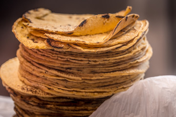 Layers of taco tortilla shells on top of each other forming a tortilla tower in a Mexican taqueria