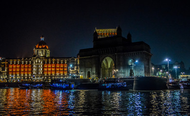 Fototapeta na wymiar Beautiful Gateway of India near Taj Palace hotel on the Mumbai harbour with many jetties on Arabian sea