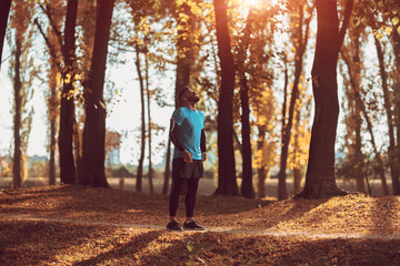 Handsome man running in the forest.