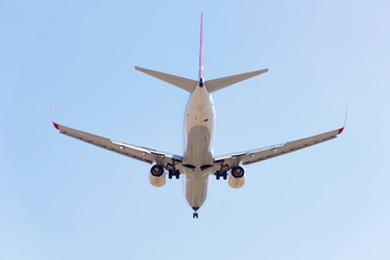 Passenger airplane landing in the airport runway. Passenger plane and blue sky with clouds. Details of airplane landing .