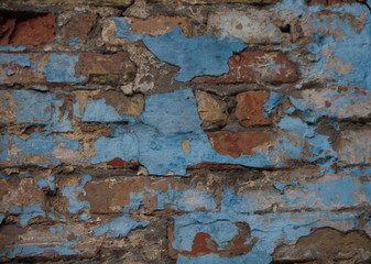 old wall. brick wall with peeling blue paint. Background
