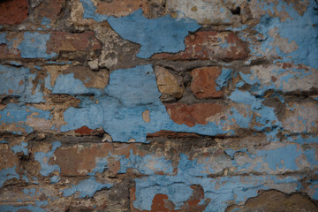 old wall. brick wall with peeling blue paint. Background