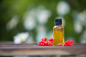 Essence of currant  on  table in beautiful glass Bottle