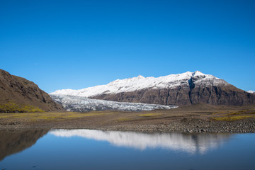 River Holmsa, Glacier Flaajokull and mountain and Flafjall mountain on a summer day in south Iceland