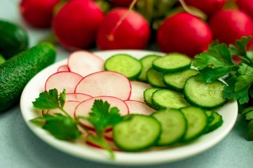 Sliced cucumbers and reddish.