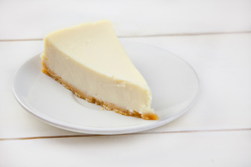 classic cheesecake on white plate on  white table