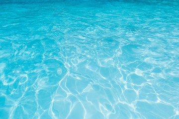 Fototapeta na wymiar Blue water surface and ripple wave in swimming pool