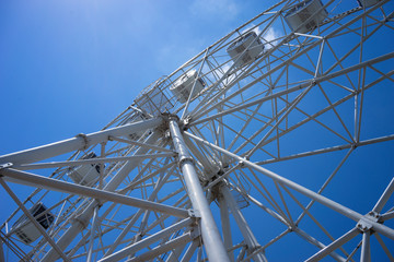 Beautiful and modern Ferris wheel on blue sky background.